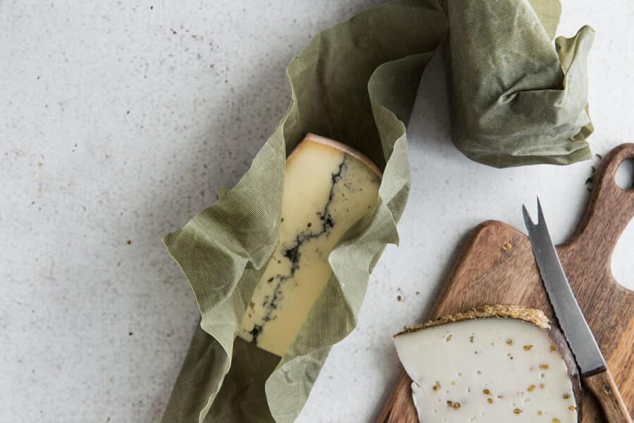 A cheese wraps in a green beeswax wrap